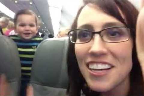 Passenger entertains baby on plane by making him laugh. So cute!