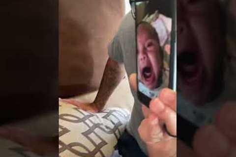 Baby looks horrified at watching herself cry