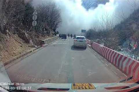 Cars reverse to avoid avalanche crashing down mountain