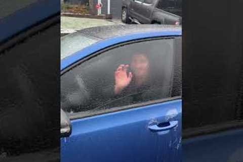 Man fearlessly punches through his car window...