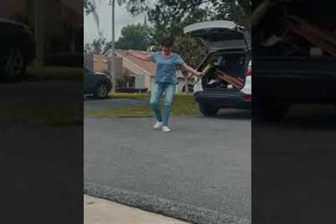 Mom shows off baton twirling skills with umbrella