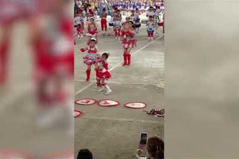 Energetic schoolgirl stands out in parade with her dance move