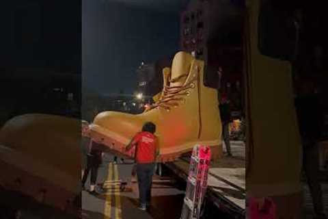 Group of men lift giant Timberland boot