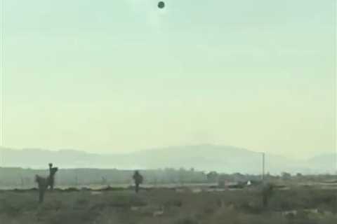 Video shows mysterious ‘black glass’ UFO floating in sky near airfield used by military contractor..