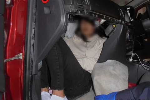 People smuggler hides illegal migrant in compartment behind car dashboard in bid to cross the..