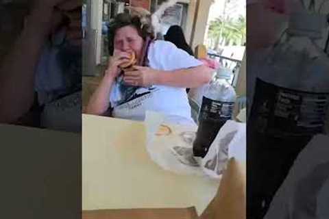 Hungry pigeon tries to eat woman's McDonald's burger