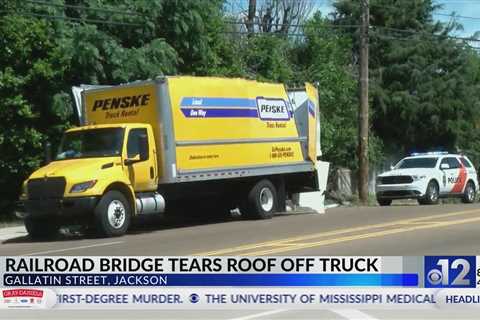 Railroad bridge in Jackson tears roof off truck