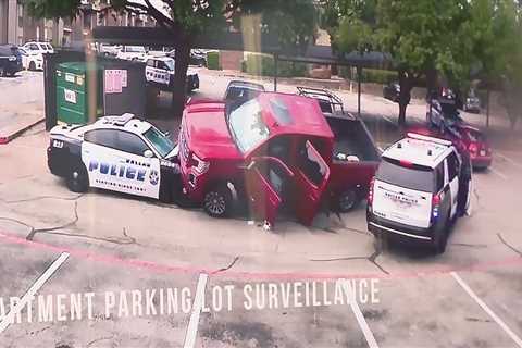 WATCH: Truck rams into Dallas police vehicle, nearly driving over it