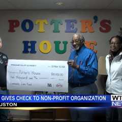 Natchez Trace Electric and TVA present check to non-profit organization in Houston